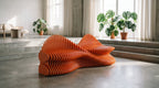 Parametric Twist Sofa, wavy slatted CNC-cut MDF sofa in orange, in a concrete room